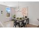 Elegant dining room with modern chandelier, stylish table decor and natural light through the window at 5015 Renvyle Dr. (Lot 12) Dr, Atlanta, GA 30339