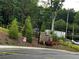 Landscaped entrance with stone accents, lush greenery, and a community sign at 5015 Renvyle Dr. (Lot 12) Dr, Atlanta, GA 30339