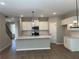 Modern kitchen with white cabinets and island at 5015 Renvyle Dr. (Lot 12) Dr, Atlanta, GA 30339