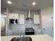 Bright kitchen features stainless appliances and sleek countertops at 5015 Renvyle Dr. (Lot 12) Dr, Atlanta, GA 30339