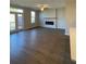 Bright living room with a fireplace, ceiling fan, and door to the patio at 5015 Renvyle Dr. (Lot 12) Dr, Atlanta, GA 30339