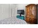 Bedroom with furnishings including TV, armoire, and chest at 5410 Whisper Ct, Cumming, GA 30028