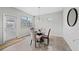 Cozy breakfast nook with a glass-top table, three windows, and a door to outside at 5410 Whisper Ct, Cumming, GA 30028