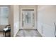 Bright entryway with white wainscoting and modern rug, creating a welcoming space at 5410 Whisper Ct, Cumming, GA 30028