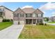 Charming two-story brick home with well-manicured front yard and attached two-car garage at 5410 Whisper Ct, Cumming, GA 30028
