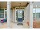 Inviting front porch with classic columns and stylish black door, creating curb appeal at 5410 Whisper Ct, Cumming, GA 30028