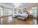 Large main bedroom with hardwood floors, two beds and a chandelier at 420 Windship Pl, Sandy Springs, GA 30327