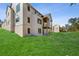 Expansive backyard featuring a large lawn and the rear elevation of the home with covered patio at 235 River Valley Court Lot 4 Ct, Atlanta, GA 30328