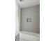 Clean bathroom featuring a white tiled wall and white tub at 235 River Valley Court Lot 4 Ct, Atlanta, GA 30328