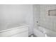 Bright bathroom features a tub with white tile surround and a white vanity with countertop at 235 River Valley Court Lot 4 Ct, Atlanta, GA 30328