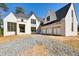 New construction home features a white brick facade, three-car garage and modern architectural details at 235 River Valley Court Lot 4 Ct, Atlanta, GA 30328