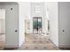Bright foyer with high ceilings, black framed glass doors, and modern design elements at 235 River Valley Court Lot 4 Ct, Atlanta, GA 30328