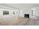 Spacious living room with fireplace, large windows offering natural light, and modern design at 235 River Valley Court Lot 4 Ct, Atlanta, GA 30328