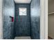 Stylish shower featuring unique blue tiling with a built-in niche and small window at 235 River Valley Court Lot 4 Ct, Atlanta, GA 30328