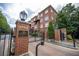 Charming brick building entrance with secure gate, lush greenery, and classic architectural design at 1735 Peachtree Ne St # 321, Atlanta, GA 30309