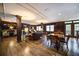 Spacious common room with a fireplace, multiple tables, hardwood flooring, and dark wood finishes at 1735 Peachtree Ne St # 321, Atlanta, GA 30309