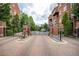 Elegant gated entrance to a brick building with manicured landscaping and a welcoming ambiance at 1735 Peachtree Ne St # 321, Atlanta, GA 30309