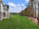 A large green field in the backyard transitions into wooded area at 216 Ewing Way, Dacula, GA 30019