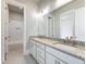 This luxurious bathroom has double granite sinks and leads to a beautifully tiled shower at 216 Ewing Way, Dacula, GA 30019