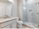 This bathroom offers a glass shower, granite countertop sink, and modern finishes at 216 Ewing Way, Dacula, GA 30019