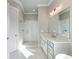 Modern bathroom with glass-enclosed shower, and white cabinets at 216 Ewing Way, Dacula, GA 30019