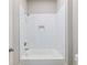 The home offers a bright white tub and shower combination with updated fixtures at 216 Ewing Way, Dacula, GA 30019