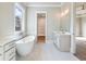 Elegant bathroom with standalone tub, dual vanities, and natural light at 216 Ewing Way, Dacula, GA 30019