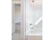 Tiled white shower and bathtub are showcased within the bathroom at 216 Ewing Way, Dacula, GA 30019