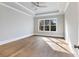 Spacious bedroom with hardwood floors, tray ceiling, ceiling fan, and large window at 216 Ewing Way, Dacula, GA 30019