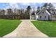 Long driveway leading to a blue home with lush green lawn at 216 Ewing Way, Dacula, GA 30019