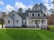 Charming two-story home with a welcoming front porch and lush green lawn at 216 Ewing Way, Dacula, GA 30019