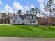 Beautiful two-story home with blue siding, a covered porch, and a green lawn at 216 Ewing Way, Dacula, GA 30019