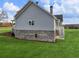Home exterior with neutral siding, brick foundation, a side porch with stairs, and a large, well-maintained lawn at 216 Ewing Way, Dacula, GA 30019