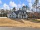 Charming home with a inviting porch, features a combination of light brown and well-kept landscaping at 216 Ewing Way, Dacula, GA 30019