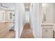 Hallway leading to a bathroom and living area with hardwood floors and modern finishes at 216 Ewing Way, Dacula, GA 30019