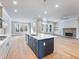 Open-concept kitchen flows into a living area with fireplace and views of the backyard at 216 Ewing Way, Dacula, GA 30019