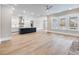 Open concept living space featuring hardwood floors, kitchen, and natural light at 216 Ewing Way, Dacula, GA 30019