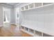 Bright mudroom with hardwood floors, built-in storage cubbies, and convenient bench seating at 216 Ewing Way, Dacula, GA 30019