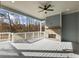 Covered porch featuring a ceiling fan, a brick fireplace, and outdoor views at 216 Ewing Way, Dacula, GA 30019