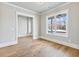 Bright, airy room with gleaming hardwood floors and views of wooded property at 216 Ewing Way, Dacula, GA 30019
