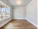 Well-lit room with hardwood floors and a large window offering neighborhood views at 216 Ewing Way, Dacula, GA 30019
