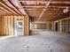 Unfinished room featuring exposed wood beams and a door to the outside at 216 Ewing Way, Dacula, GA 30019