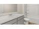 Well-lit bathroom with a white vanity, stylish countertop, toilet, and shower-tub combination at 8593 Preakness Pass, Lithonia, GA 30058