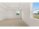 Bright bedroom showcasing neutral-tone walls, carpeting and two windows allowing for plenty of natural light at 8593 Preakness Pass, Lithonia, GA 30058