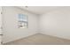 Bright bedroom featuring neutral walls and carpet, and a window providing natural light at 8593 Preakness Pass, Lithonia, GA 30058