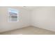 Bright bedroom featuring neutral carpet, white walls, and a window with natural light at 8593 Preakness Pass, Lithonia, GA 30058