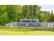 Serene community entrance featuring stone signage, a water feature, and well-maintained greenery at 8593 Preakness Pass, Lithonia, GA 30058