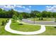 Scenic community landscape with sidewalks, lush green areas, and professionally designed plantings at 8593 Preakness Pass, Lithonia, GA 30058