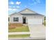 Charming single-story home featuring a manicured lawn, two-car garage, and classic architectural details at 8593 Preakness Pass, Lithonia, GA 30058