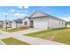 Comfortable one-story house with a green lawn, a convenient two-car garage, and familiar architectural touches at 8593 Preakness Pass, Lithonia, GA 30058